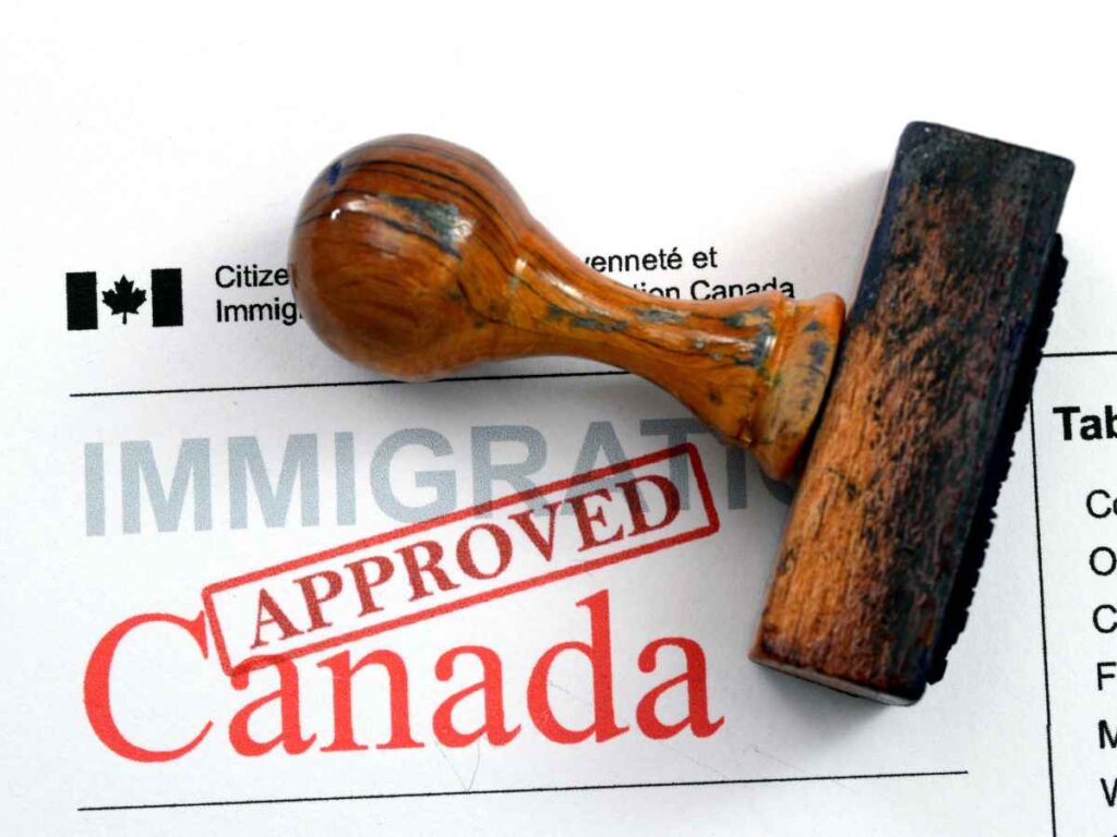 Canadian immigration paperwork and approval stamp representing family immigration records