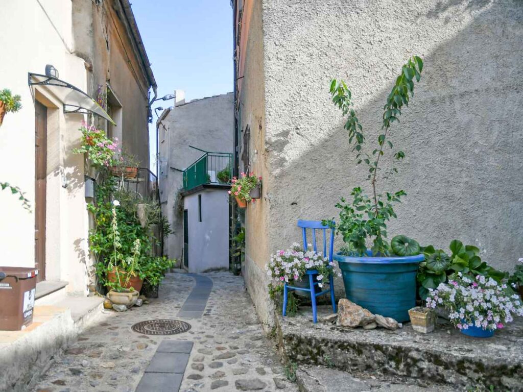 Quiet residential lane with flowers in an old southern Italian village