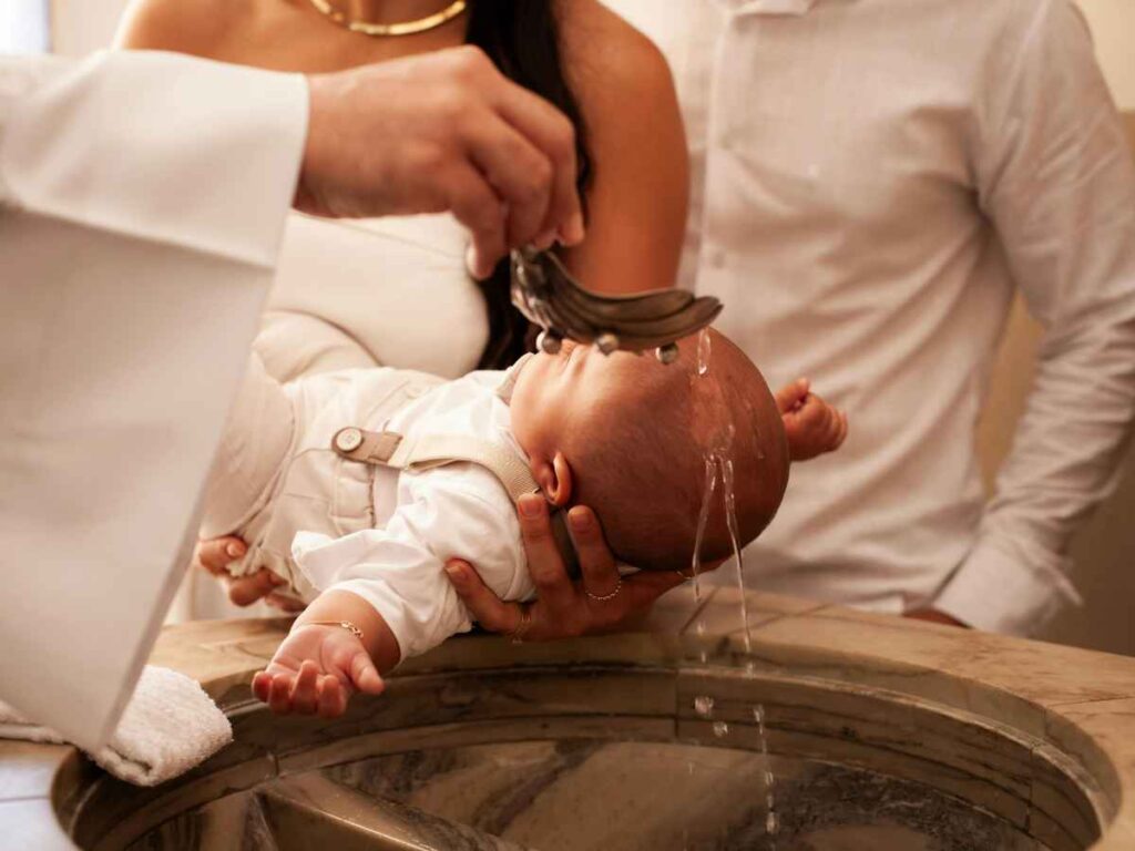Parents and godparents gathered around a baby during an Italian Catholic baptism